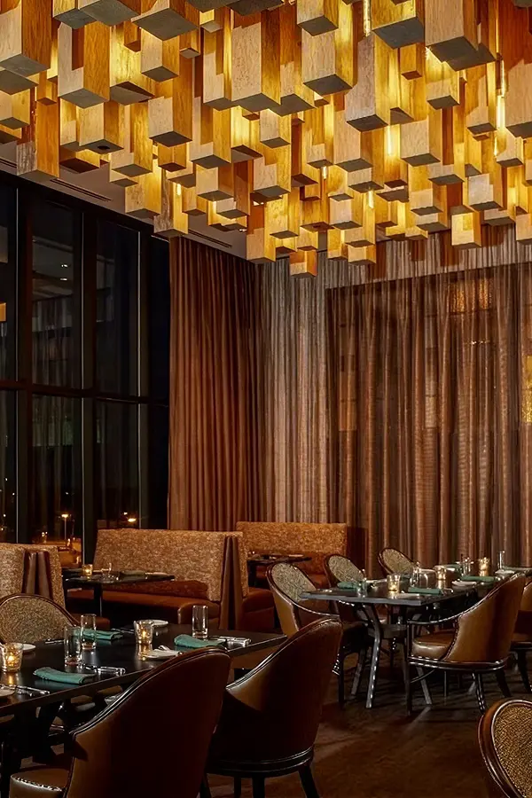 Upscale bar with geometric wood ceiling lights