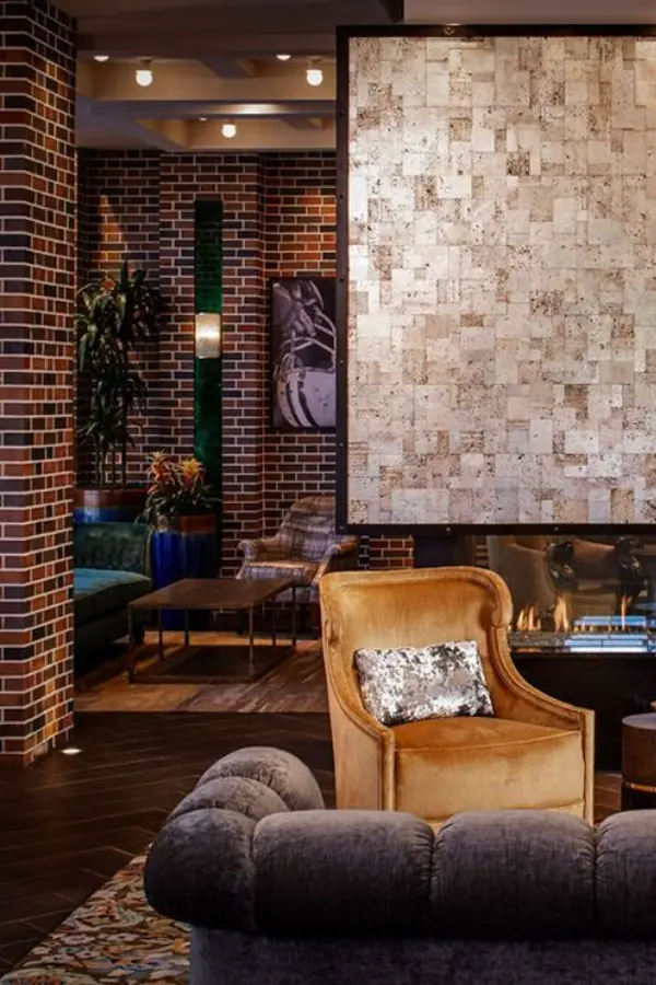 Hotel lobby with brick walls and velvet armchairs